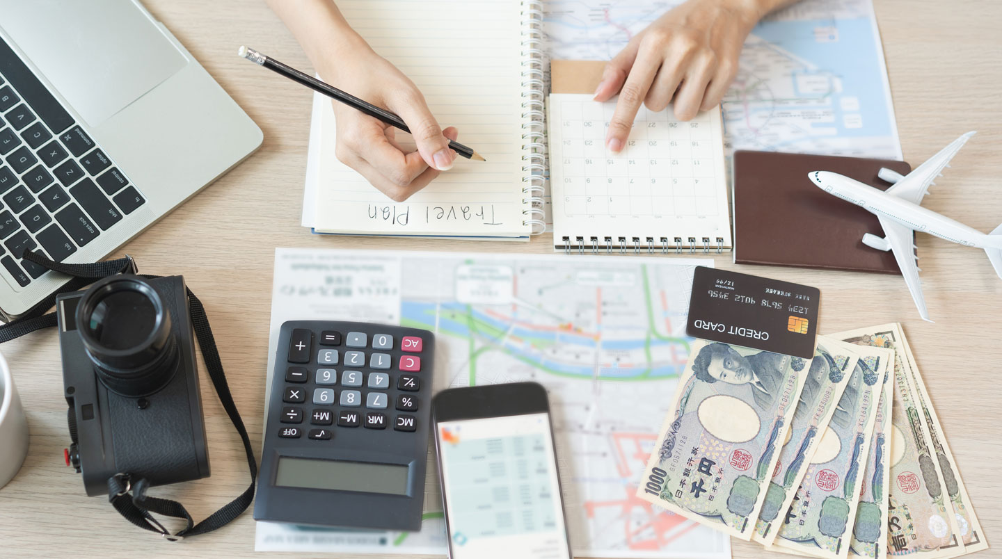 Seasonal pricing calendar with color-coded rates and booking app interface on clean desk surface